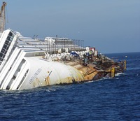 The cruise ship Costa Concordia lays on its side partially submerged