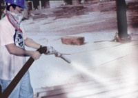 Historical image of a worker sandblasting asbestos without breathing protection