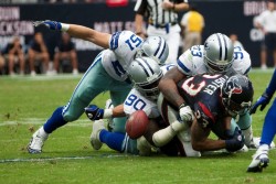 A player is tackled in a football game