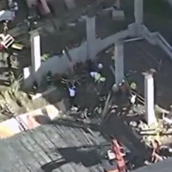 Daytime aerial view of a Lynn construction site accident that left workers trapped under rebar